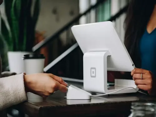 A customer paying at a small business counter