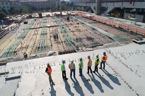 A construction crew on site reviewing the day's work