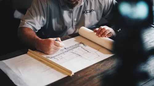 A contractor marking up drawings at a desk