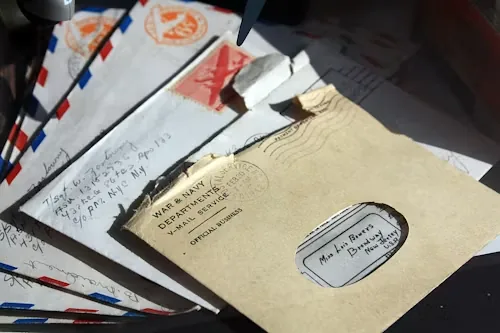 A stack of vintage airmail envelopes with red and blue borders